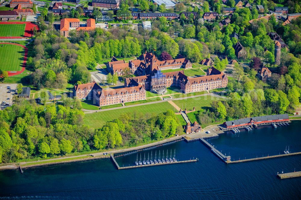 Aerial photograph Flensburg - The Naval School Muerwik, abbreviation MSM, is the training center for officers and officer candidates of the navy with its subordinate sailing training ship Gorch Fock. In the district of Flensburg-Muerwik, the foundation stone was laid in 1907 for the building erected according to the generous plans of the Naval Building Authority Kelm. The external design of the MSM, which is also called the Red Castle on the sea, is very similar to the historic buildings of the East Prussian Marienburg of the Teutonic Knights