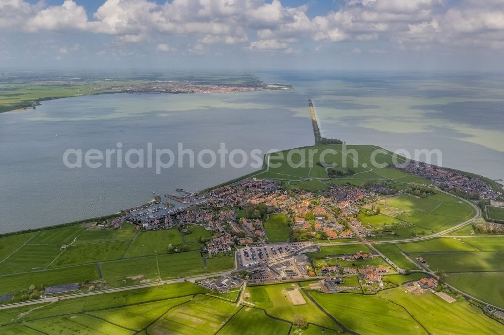 Marken from the bird's eye view: View of the island Marken with view of the harbor and the districts Havenbuurt, Kerkbuurt and De Kets in the province North Holland in the Netherlands. The island is located in the Markenmeer and has an completed and an inchoate dike. The completed dike connects Marken with the mainland