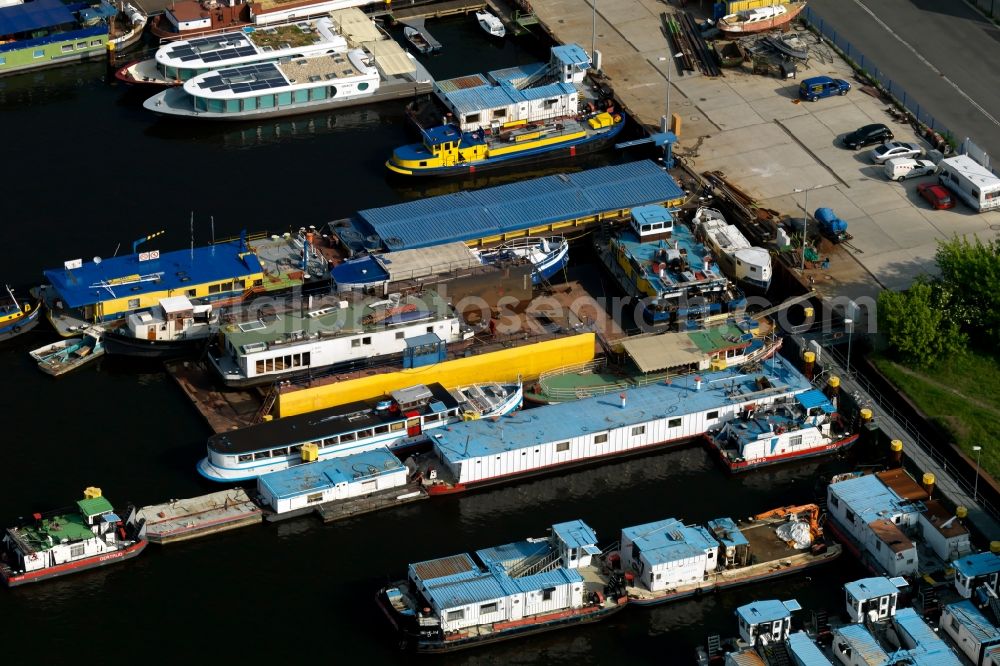 Aerial image Berlin - MBS dock and thrust units of cargo ships - barges on the shore of Lake Rummelsburg in Berlin Treptow