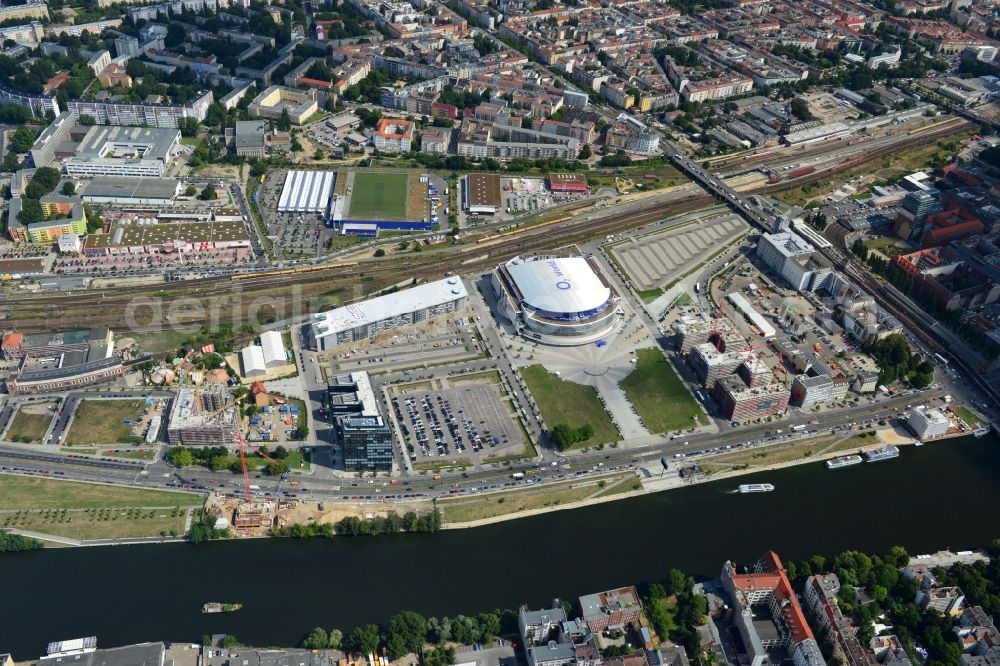 Berlin from the bird's eye view: View at the Media Spree area at the Spree near Ostbahnhof between Oberbaum Bridge and Schilling Bridge in the district of Kreuzberg-Friedrichshain in Berlin. Media Spree is one of the biggest investors projects in Berlin. It aims the establishment of communications and media companies along an area approximately 3.7 km long and is appropriate to restructure. The picture shows among others the O2 Arena, the East Side Gallery, the former Post Station and the Oberbaum Bridge