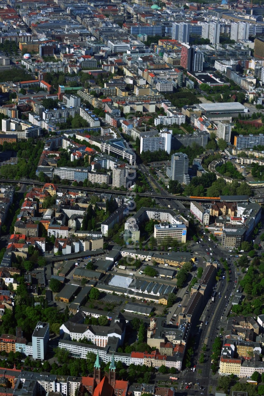 Berlin from above - The Mehring Damm, a major traffic thoroughfare of the capital, will meet at Hallesches Ufer road on the Wilhelmstrasse and Stresemannstraße. Here in the trendy district of Kreuzberg in Berlin, there are many cafes, restaurants and small shops with interesting offers. Along the Landwehr Canal, the famous subway line runs 1. In the branch Stresemann-Wilhelmstrasse, the party headquarters of the SPD is in the Willy-Brandt-Haus. At the bottom of the towers of St. Boniface Church can be seen