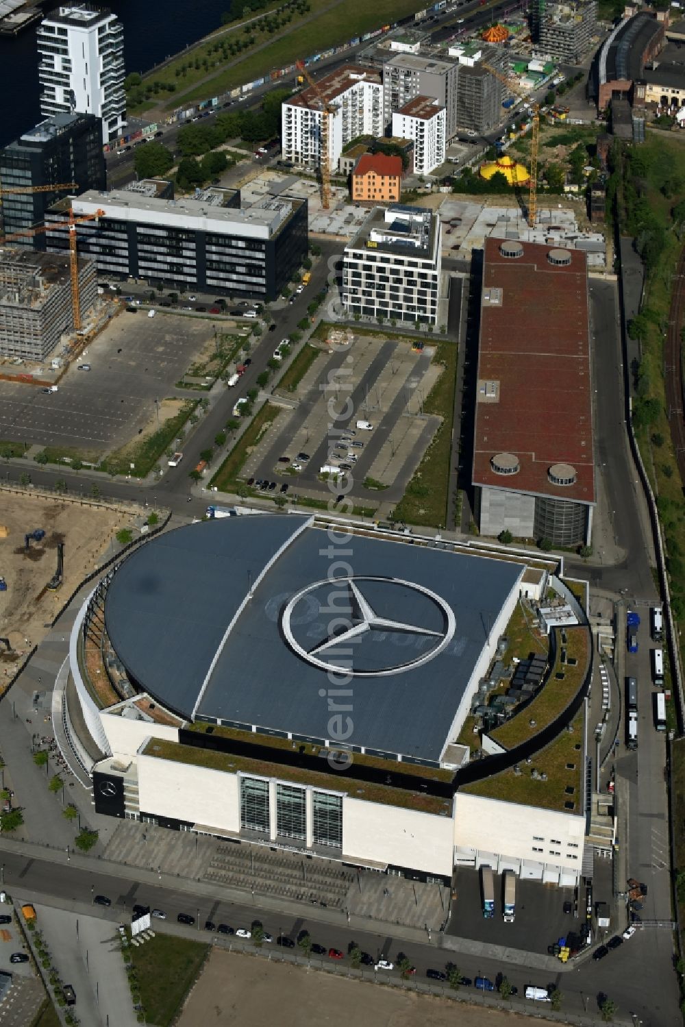 Berlin from above - Mercedes-Benz-Arena on the Spree riverbank in the Friedrichshain part of Berlin. The former O2 World - now Mercedes-Benz-Arena - is located in the Anschutz Areal, a business and office space on the riverbank