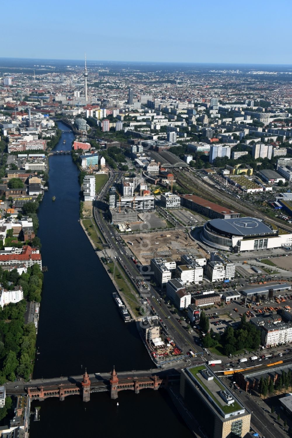 Berlin from above - Mercedes-Benz-Arena on the Spree riverbank in the Friedrichshain part of Berlin. The former O2 World - now Mercedes-Benz-Arena - is located in the Anschutz Areal, a business and office space on the riverbank