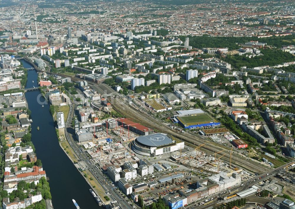 Berlin from above - Night view of Mercedes-Benz-Arena on the Spree riverbank in the Friedrichshain part of Berlin. The former O2 World - now Mercedes-Benz-Arena - is located in the Anschutz Areal, a business and office space on the riverbank