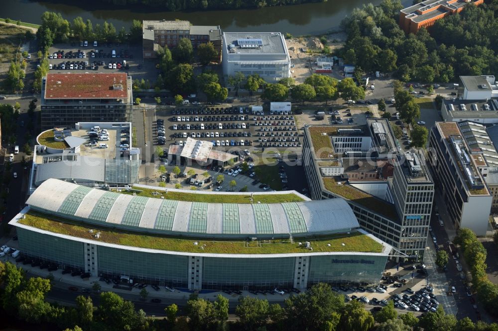 Aerial photograph Berlin - The Mercedes-Benz Berlin branch is located on the Salzufer in Berlin-Charlottenburg. Here is the complete package will be offered to car buying and selling, financial services, and service. For leisure activities, the building is used, so for auto sports, there is an indoor climbing wall and a children's traffic school. The building, also known as Mercedes World, follows with a sweep the barrel of the Landwehr Canal. Was built, the glass-steel construction according to designs by architects Lamb, Weber, Donath and partners