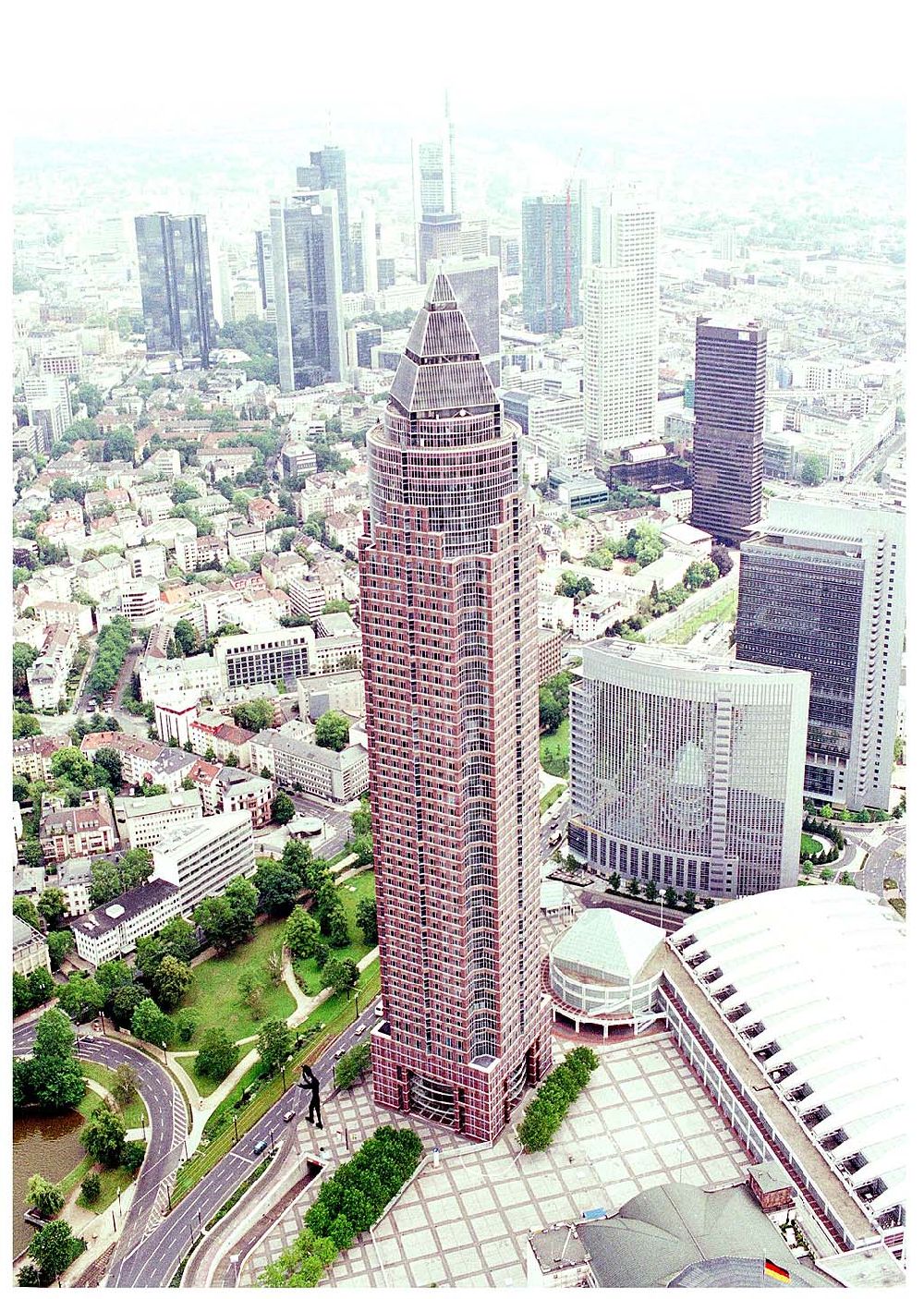 Aerial image Frankfurt am Main - 25.07.2004 Blick auf den Messeturm in Frankfurt am Main mit einer Höhe von 257m und 55 Etagen. Die Pyramide auf dem Dach ist 36,6m hoch. Errichtet wurde das Hochhaus von Tishman Speyer und der Citibank, dann 1991 an die Kajima Corporation verkauft. Adresse: Friedrich-Ebert-Anlage 49, 60308 Frankfurt