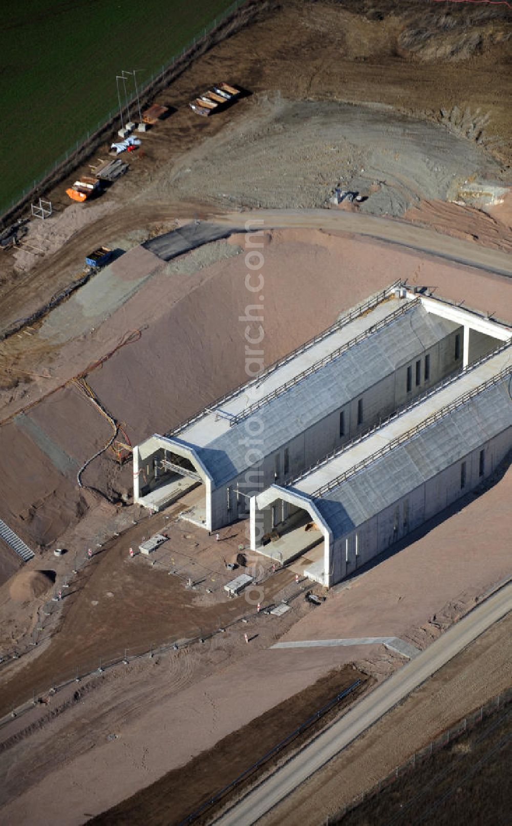 Aerial photograph Bad Bibra - View of the construction works at Bibra tunnel, a tunnel construction project by the Marti AG. The railway tunnel is created as a part of the German Unity Transport Project (VDE) No. 8. The building is created by spraying concrete with the inner shell in-situ concrete. The length of the two tunnels of the railway tracks will be 6466 meters. Client is the DB InfraGO AG