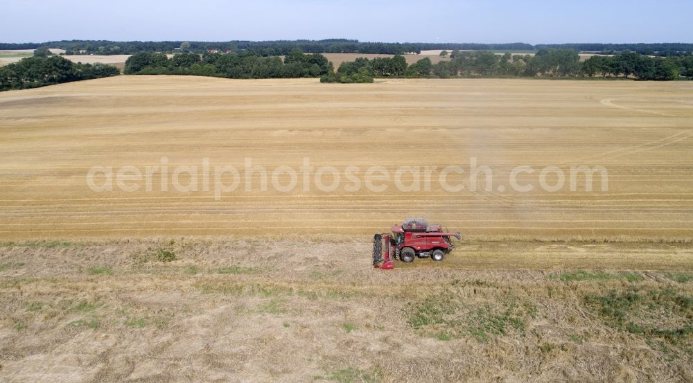 Aerial image Zapel - Harvester-thresher on a grain field at harvest time in Zapel in the state Mecklenburg - Western Pomerania, Germany