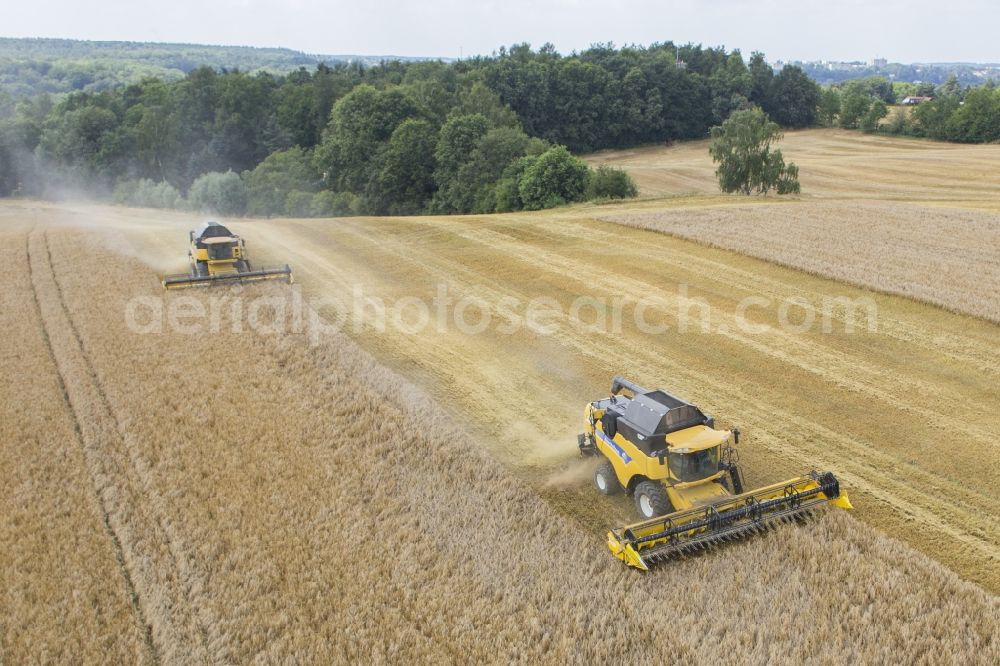 Grimma from above - Combines the harvest - to use a field in agriculture in Grimma in Saxony