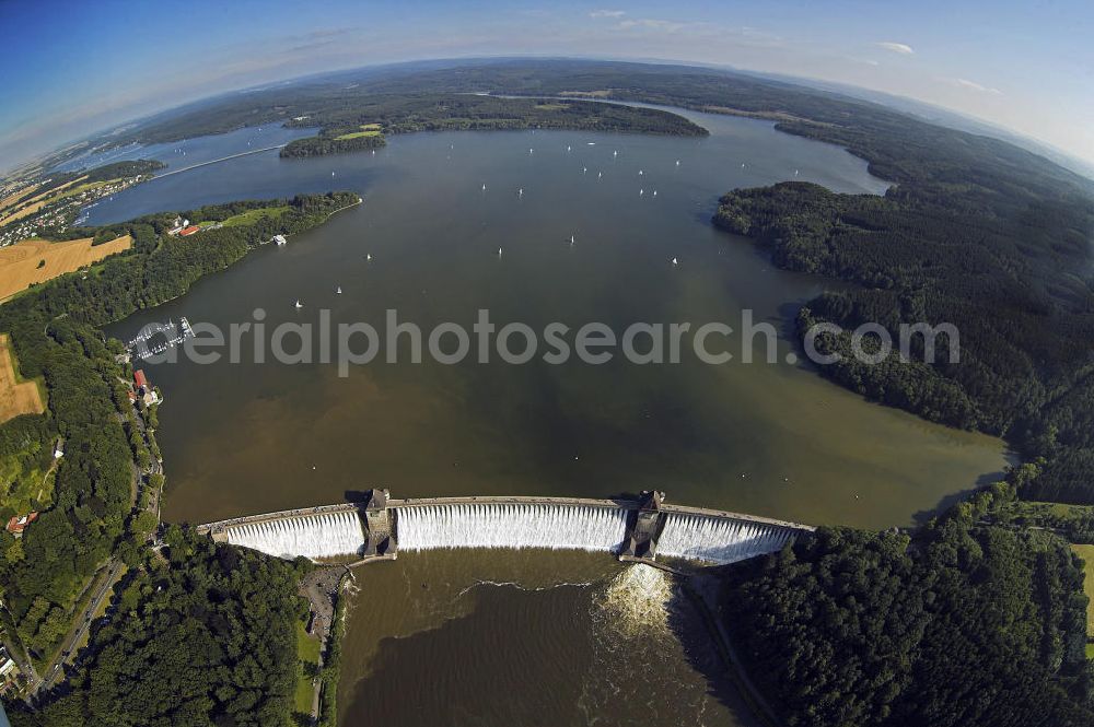 Aerial image Möhnesee - Blick auf die Möhnetalsperre mit Staumauer und Stausee während des Hochwassers 2007. Die Talsperre wurde zwischen 1908 und 1913 erbaut und umfasst rund 134,5 Millionen Kubikmeter Wasser. Die Mauer hat eine Kronenlänge von 650 m und eine Höhe von insgesamt 215 m. View of the dam and reservoir of the Moehne barrage during the flood 2007. The dam was built between 1908 and 1913 and the reservoir comprises approximately 134.5 million cubic meters of water. It has a crest length of 650 m and a height of 215 m.