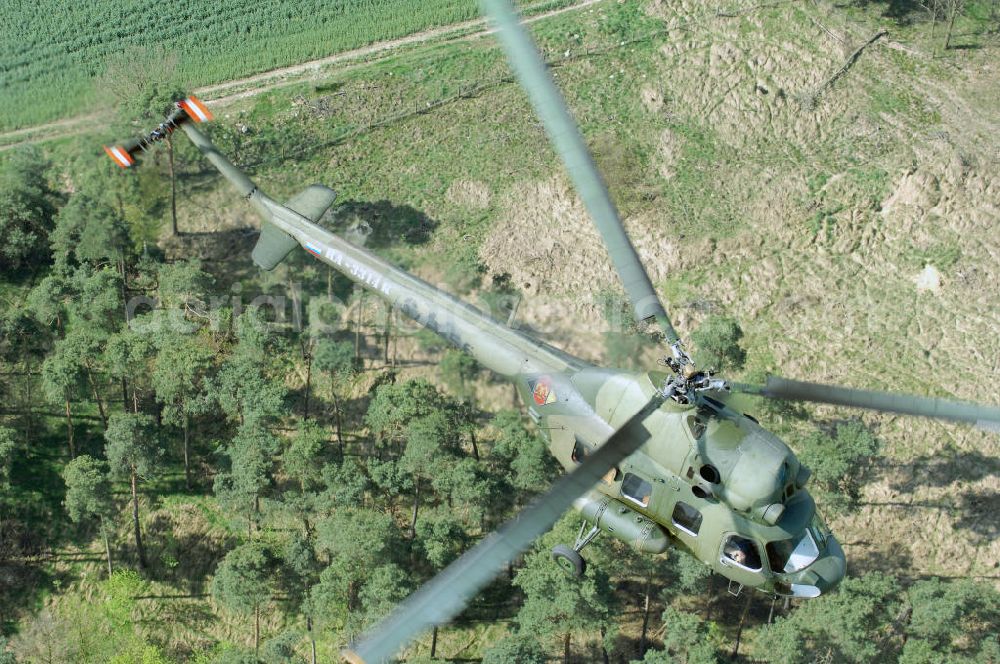 Aerial image Finow - MI-2 Helikopter in Bemalung der ehemaligen NVA-Luftstreitkräfte (Nationale Volksarmee) der DDR mit noch am Rumpf sichtbarer taktischer Nummer der Bundeswehr im Anflug auf den Flugplatz Finow / Eberswalde zum historischen Oldtimertreffen auf dem Freigelände der Luftfahrthistorischen Sammlung. Das Luftfahrzeug fliegt heute unter der russischen Kennung RA-3314 K.