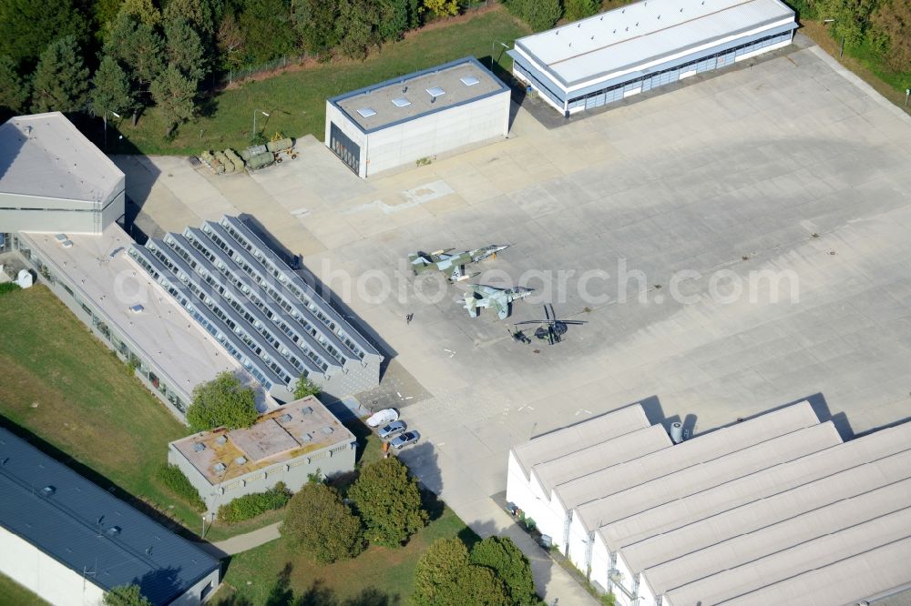 Unterhaching from the bird's eye view: Military airplanes and helicopter on site of the University of the Bundeswehr Munich in Unterhaching in the state of Bavaria. The two jets and the helicopter are located in front of hangars and outbuildings