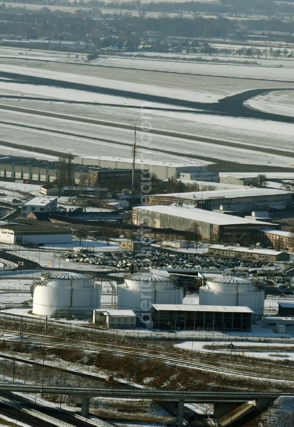 Schönefeld from above - Snowy mineral oil - tanks on the airport area in winter in Schoenefeld in the state Brandenburg