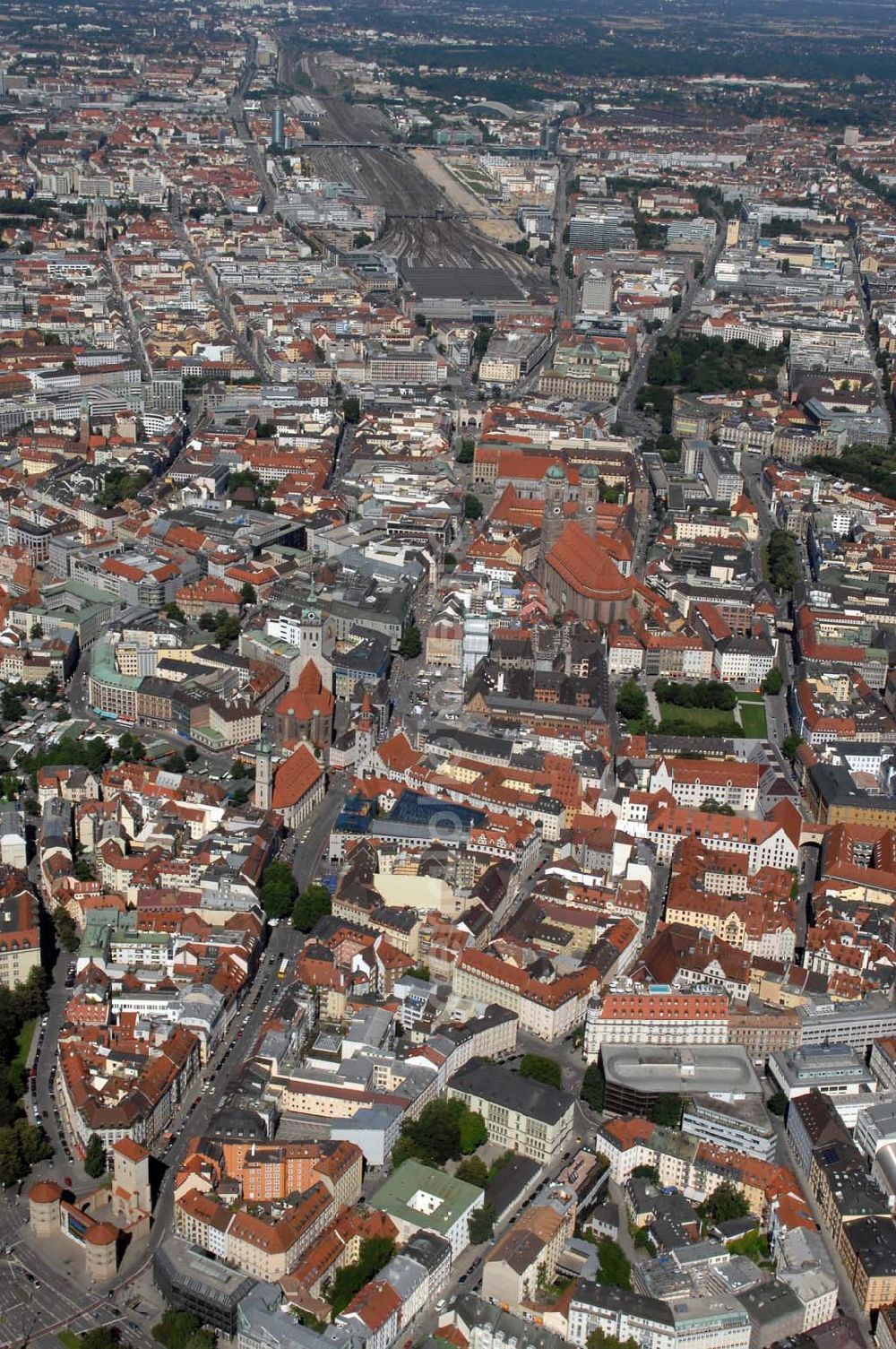 München from above - Blick auf die Altstadt München mit der Frauenkirche, dem Neuen Rathaus am Marienplatz und Alten Rathaus, sowie St. Peter Kirche und die Heilig-Geist-Kirche. Im Hintergrund ist der Hauptbahnhof zu sehen. Munich 2007/07/14 Old-town of Munich. Visible are the Frauenkirche, the New Town Hall at the Marienplatz, the Old Town Hall, as well as the St.Peter-Church and the Church of the Holy Ghost. In the background you can see the Central Station.