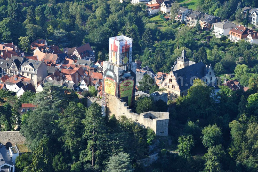 Aerial image Kronberg im Taunus - Blick auf eine Maggiflasche als Großwerbeplakat auf der Einrüstung der Burg Kronberg. Zum 125-jährigen Jubiläum der Maggi-Würzsoße wurde der im Volksmund als Maggi-Flasche bezeichnete Turm des Kronberger Wahrzeichens für drei Monate als Werbeträger genutzt. Die Werbeeinnahmen der NESTLE Gruppe fließen unmittelbar in die Burgsanierung. View a bottle of Maggi at Burg Kronberg.