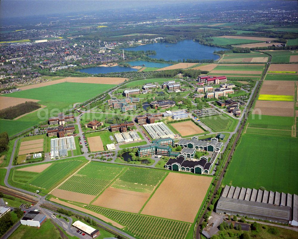 Monheim am Rhein from the bird's eye view: Stadtansicht auf Monheim in Nordrhein-Westfalen mit der Bayer CropScience GmbH. Die Stadt liegt am Rhein und ist eine mittlere Kreisstadt. Town view of Monheim in North Rhine Westphalia with the Bayer CropScience GmbH. The town is locatet at the Rhine River and is a small county town.