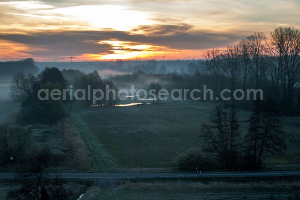 Aerial photograph Minfeld - Sunrise haze at structures of a field landscape Otterbachtal in Minfeld in the state Rhineland-Palatinate