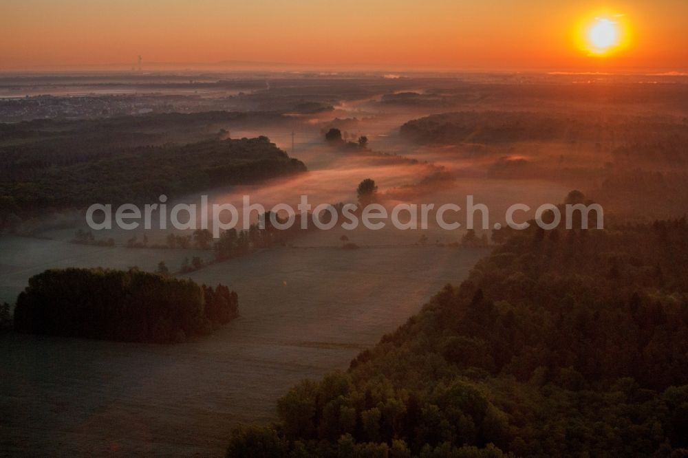 Minfeld from the bird's eye view: Sunrise haze at structures of a field landscape Otterbachtal in Minfeld in the state Rhineland-Palatinate