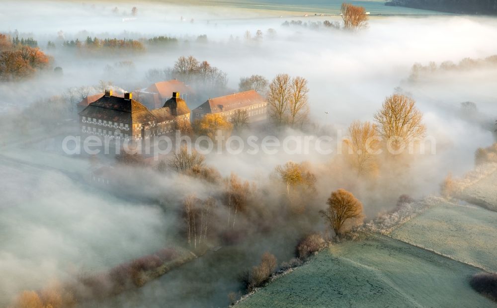 Hamm from the bird's eye view: Morning mist over the lip and the meadows of the Lippeauen at sunrise on Oberwerries Castle in Hamm in North Rhine-Westphalia