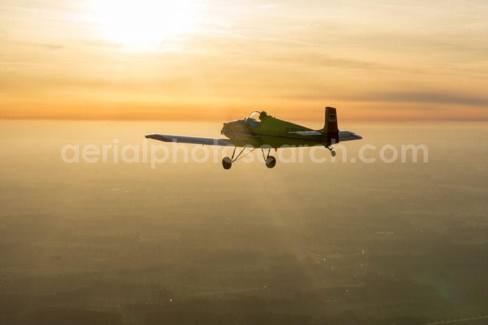 Aerial image Bremervörde - Single-seater sport aircraft Stark Turbulent D-EFUF while sunset light over the airspace in Bremervoerde in the state Lower Saxony, Germany