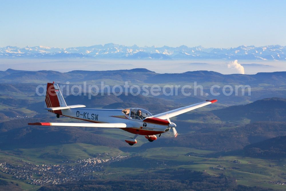 Aerial photograph Rheinfelden (Baden) - Scheibe SF 25 CR Falke with callsign D-KLSW in flight in the airspace over Rheinfelden (Baden) in the state Baden-Wuerttemberg and clear views over the mountains and hills of the Swiss Jura to the Alps.