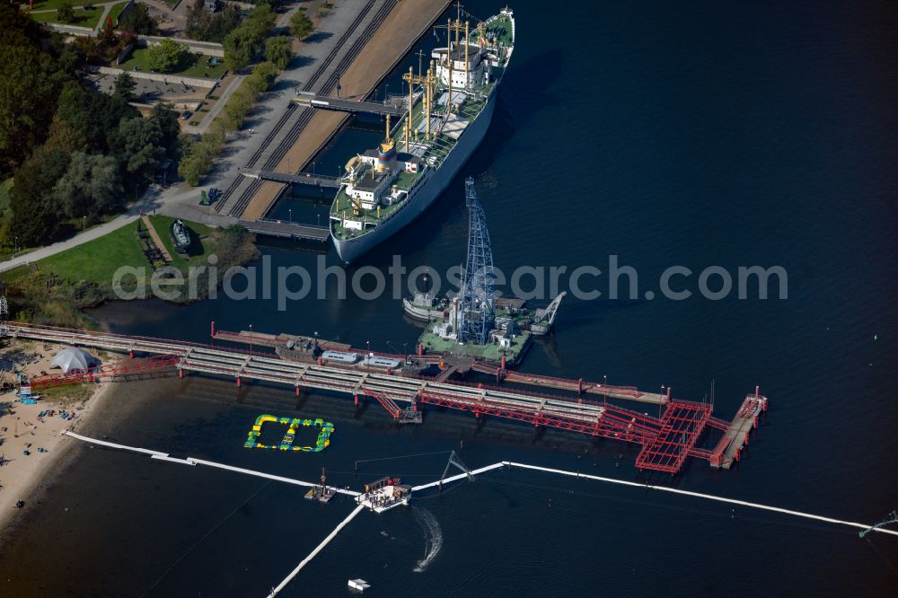 Aerial photograph Rostock - Museum building ensemble of Schifffahrtsmuseum Rostock with Schwimmkran LANGER HEINRICH and Betonschiff Capella in Rostock at the baltic coast in the state Mecklenburg - Western Pomerania, Germany