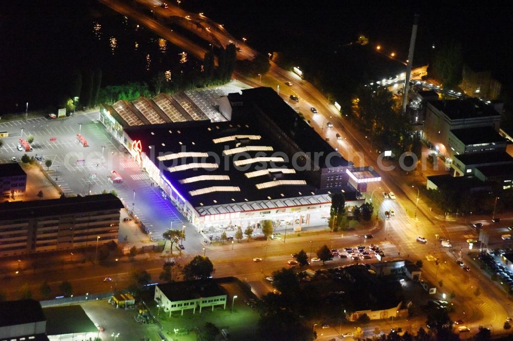 Berlin from above - Night view Building of the construction market Bauhaus Schnellerstrasse federal road B96a Karlshorster Strasse in Berlin