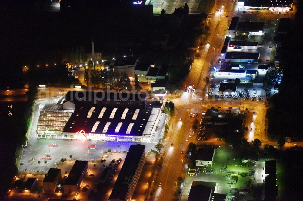 Aerial image Berlin - Night view Building of the construction market Bauhaus Schnellerstrasse federal road B96a Karlshorster Strasse in Berlin