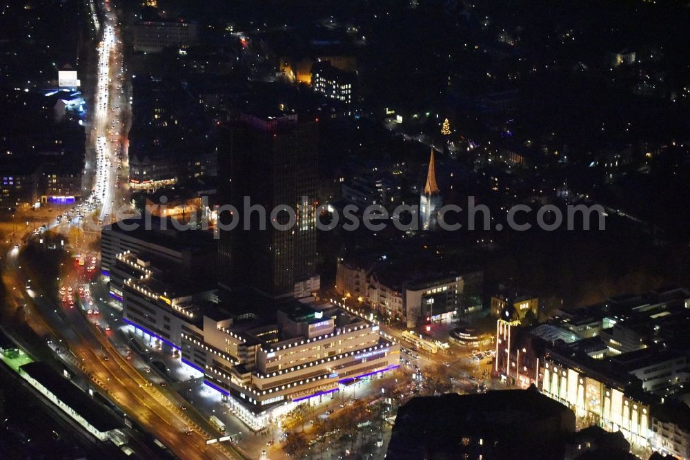 Berlin from the bird's eye view: Night view of the Steglitzer Kreisel, a empty building complex with an office tower in Berlins district of Steglitz