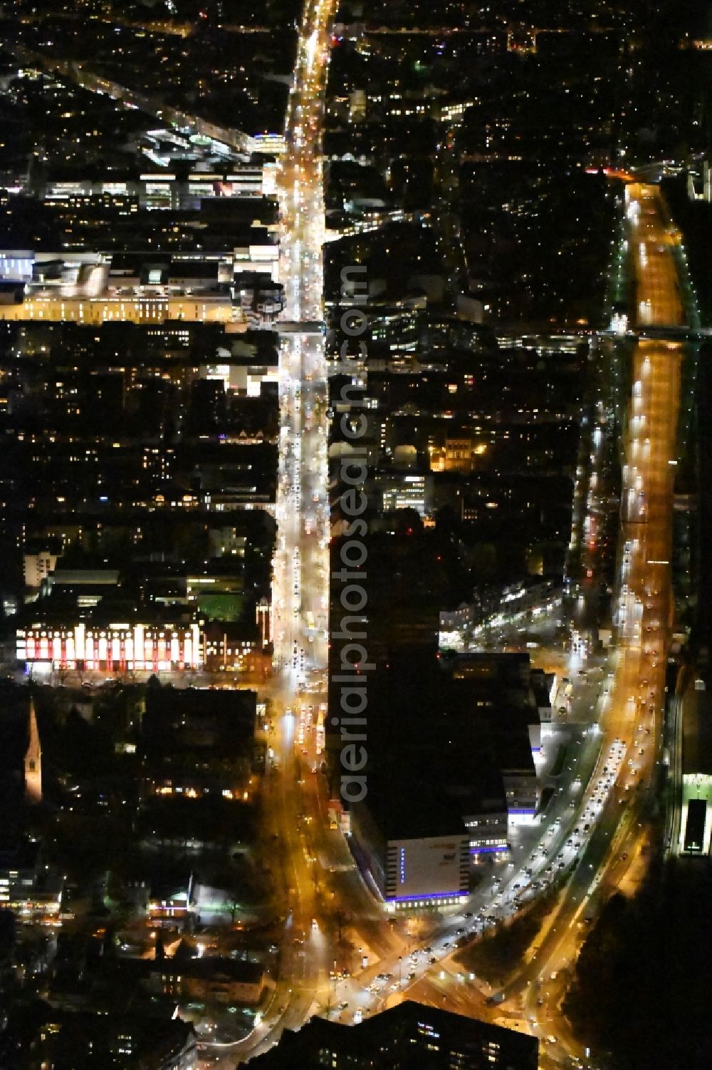 Berlin from the bird's eye view: Night view of the Steglitzer Kreisel, a empty building complex with an office tower in Berlins district of Steglitz