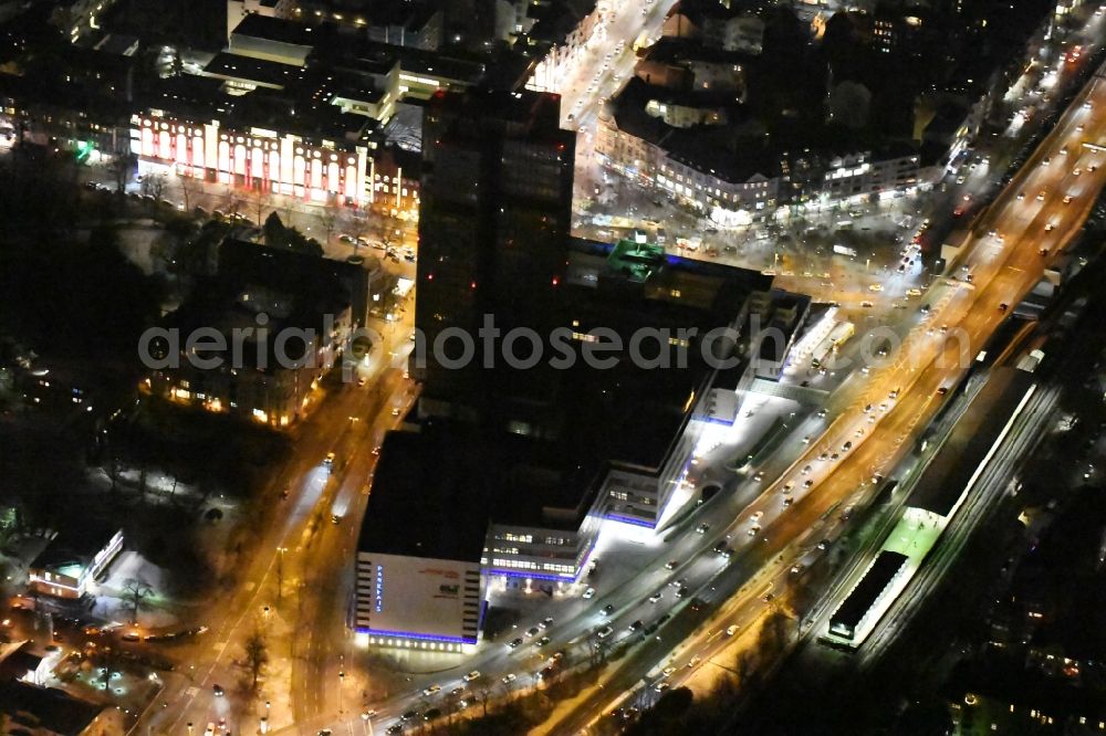 Berlin from above - Night view of the Steglitzer Kreisel, a empty building complex with an office tower in Berlins district of Steglitz