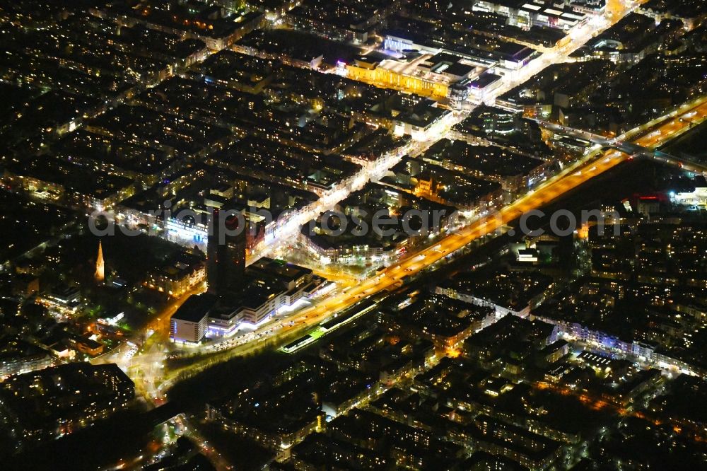 Berlin from above - Night view of the Steglitzer Kreisel, a empty building complex with an office tower in Berlins district of Steglitz