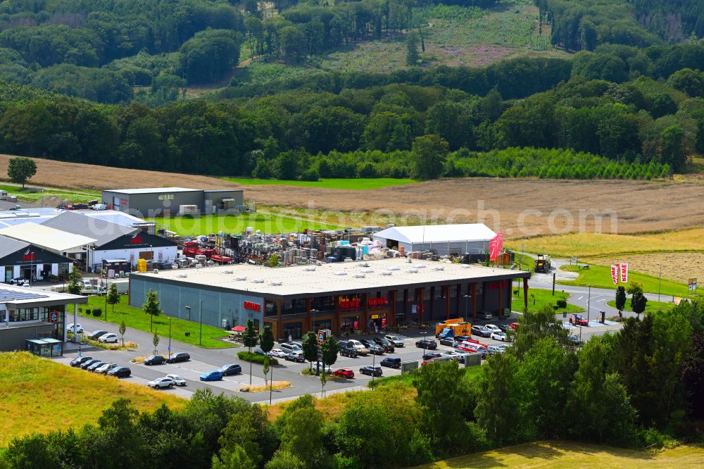 Sankt Katharinen from the bird's eye view: Building complex of local supply center REWE Florian Weller on street Am Rennenberg in Sankt Katharinen in the state Rhineland-Palatinate, Germany