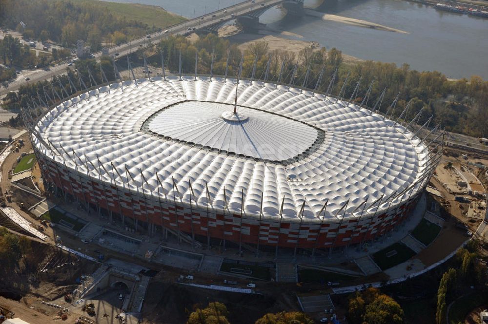 Aerial image Warschau / Warszawa / Warsaw - Das neu errichtete Stadion Warschauer Nationalstadion im Stadtteil Praga am Weichselufer gegenüber dem Warschauer Zentrum in der Woiwodschaft Masowien, Polen. Das Fußballstadion ist ein Austragungsort der UEFA Fußball-Europameisterschaft EM 2012. Generalplaner des Stadion-Neubau ist ein Konsortium aus den Architekturbüros JSK Architekten, Gerkan, Marg und Partner sowie dem Ingenieurbüro Schlaich Bergermann und Partner. Die Hochbauarbeiten wurden durch die ALPINE - PBG SA und die Hydrobudowa Polska SA ausgeführt. The new built stadium National Stadium in Warsaw in the voivodeship Masovia, Poland.