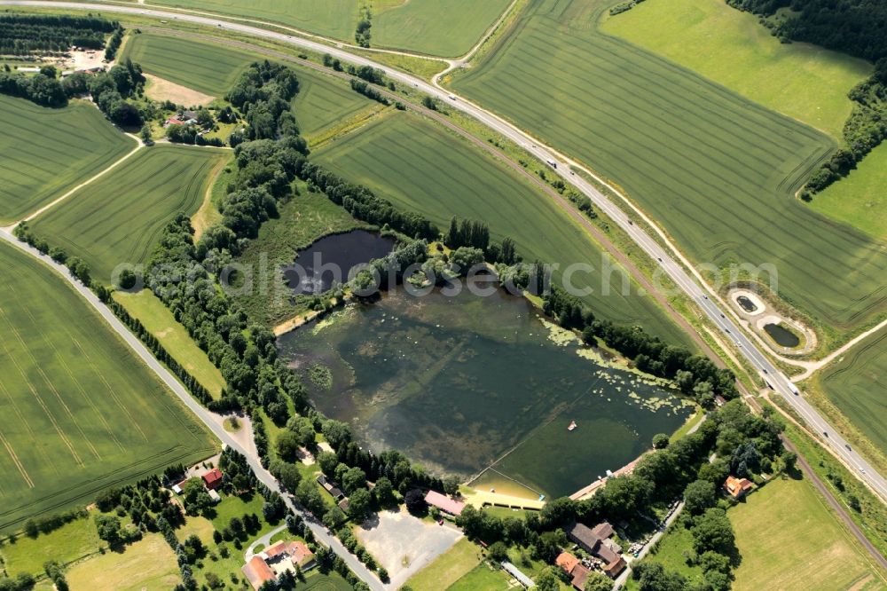 Sondershausen from the bird's eye view: The natural swimming Bebraer ponds located on the southwestern outskirts of Sondershausen in Thuringia. The ponds were created in the 11th century by monks. The ponds are fed by the river Bebra. The outdoor pool has a diving board, shallow area and a large lawn