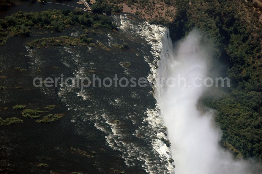 Aerial photograph Victoria Falls - Natural spectacle of the waterfall in the rocky landscape on sambesi river in Victoria Falls in Matabeleland North Province, Zimbabwe