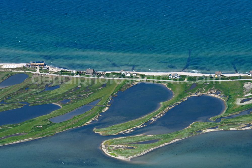 Heiligenhafen from above - Sandy beach landscape along the coastline on the shore of the Baltic Sea with houses and buildings of the Nature Reserve & NABU Center Graswarder on the street Graswarderweg in the district of Graswarder in Heiligenhafen on the Baltic Sea coast in the federal state of Schleswig-Holstein, Germany