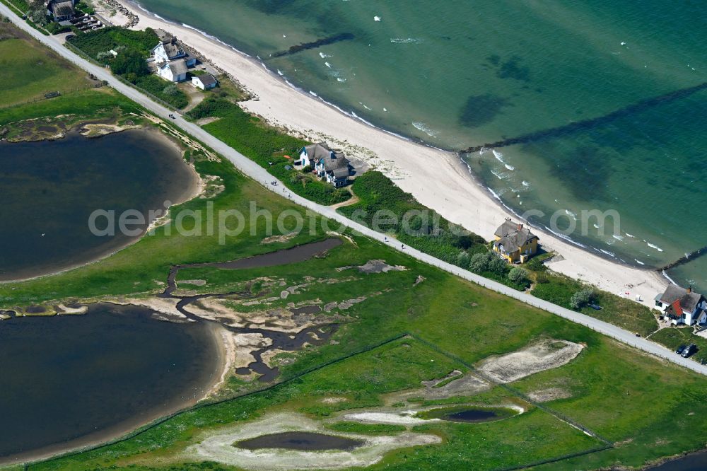 Heiligenhafen from the bird's eye view: Sandy beach landscape along the coastline on the shore of the Baltic Sea with houses and buildings of the Nature Reserve & NABU Center Graswarder on the street Graswarderweg in the district of Graswarder in Heiligenhafen on the Baltic Sea coast in the federal state of Schleswig-Holstein, Germany