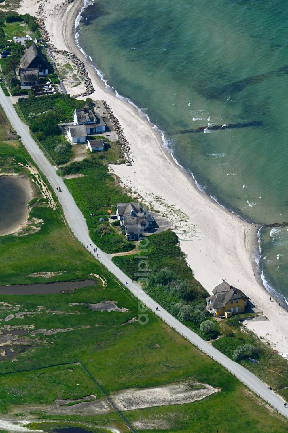 Heiligenhafen from above - Sandy beach landscape along the coastline on the shore of the Baltic Sea with houses and buildings of the Nature Reserve & NABU Center Graswarder on the street Graswarderweg in the district of Graswarder in Heiligenhafen on the Baltic Sea coast in the federal state of Schleswig-Holstein, Germany