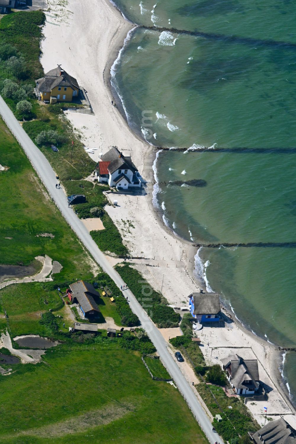 Heiligenhafen from the bird's eye view: Sandy beach landscape along the coastline on the shore of the Baltic Sea with houses and buildings of the Nature Reserve & NABU Center Graswarder on the street Graswarderweg in the district of Graswarder in Heiligenhafen on the Baltic Sea coast in the federal state of Schleswig-Holstein, Germany