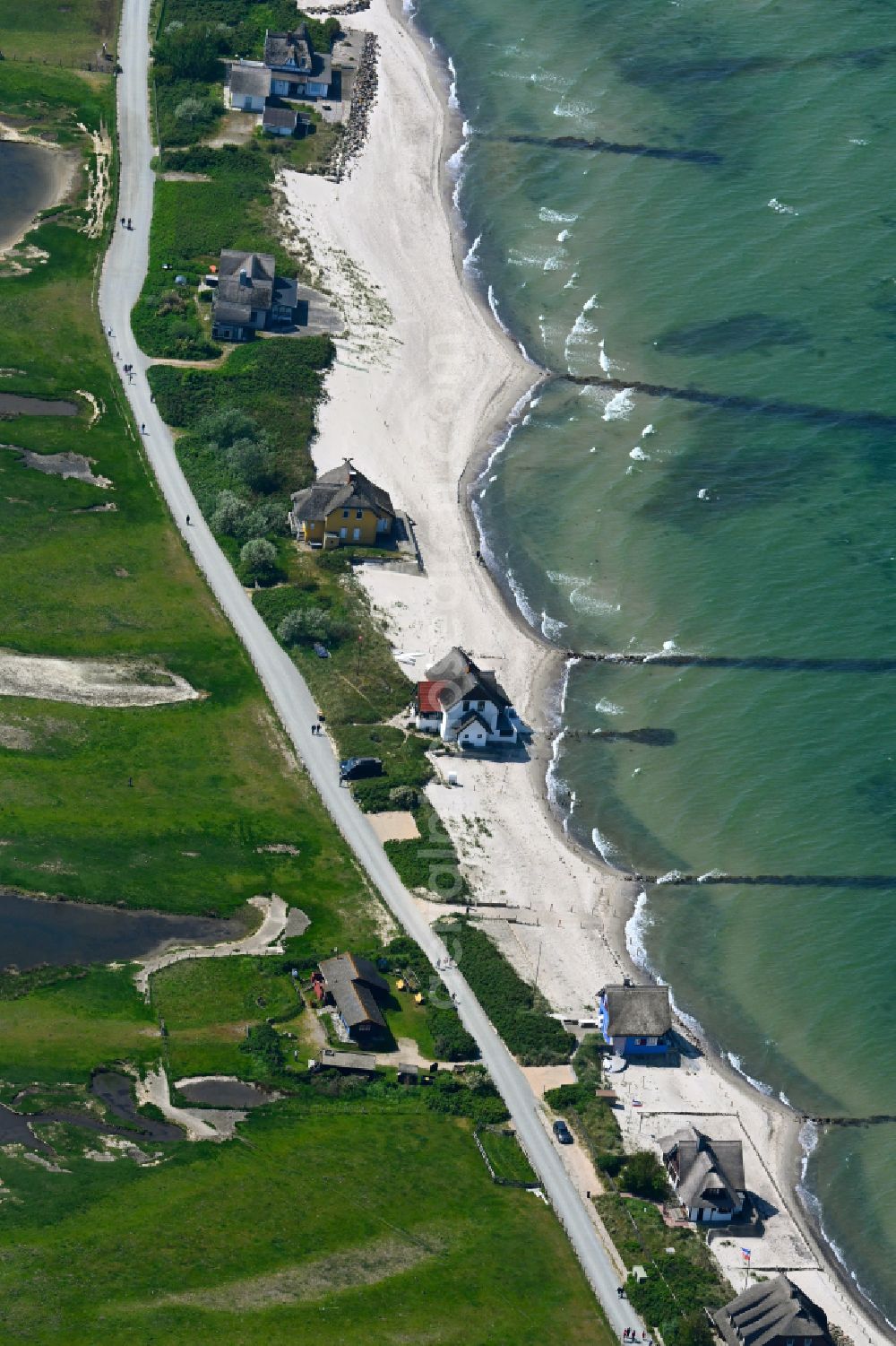 Aerial image Heiligenhafen - Sandy beach landscape along the coastline on the shore of the Baltic Sea with houses and buildings of the Nature Reserve & NABU Center Graswarder on the street Graswarderweg in the district of Graswarder in Heiligenhafen on the Baltic Sea coast in the federal state of Schleswig-Holstein, Germany