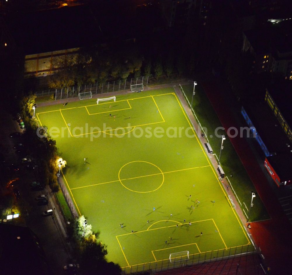 Berlin from the bird's eye view: Nightly lighted sports court - football field at the Hauffstrasse - Spirtastrasse in Rummelsburg district in Berlin