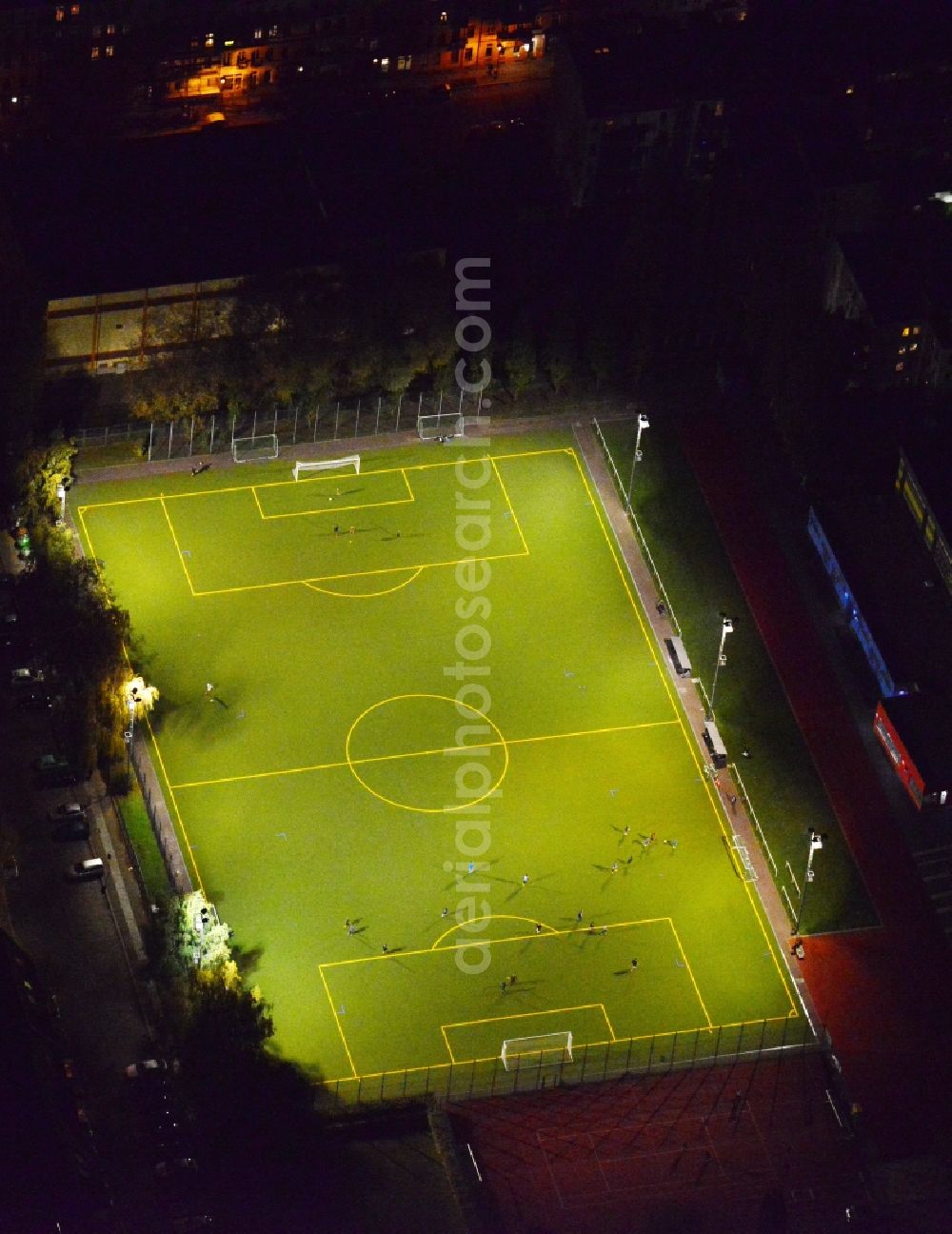 Aerial image Berlin - Nightly lighted sports court - football field at the Hauffstrasse - Spirtastrasse in Rummelsburg district in Berlin