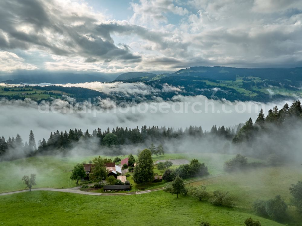 Aerial image Irsengund - Weather related fog banks and cloud layer over forest and meadow landscape in Irsengund allgaeu in the state Bavaria, Germany