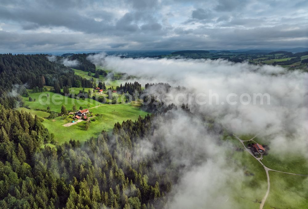 Irsengund from the bird's eye view: Weather related fog banks and cloud layer over forest and meadow landscape in Irsengund allgaeu in the state Bavaria, Germany