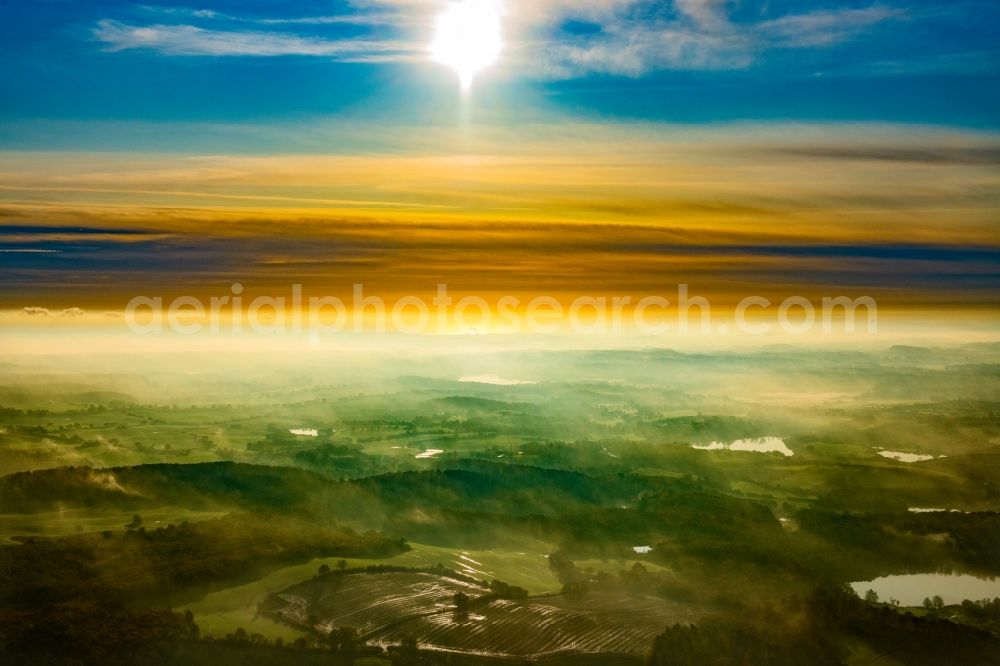 Malente from above - Weather related fog banks and cloud layer in Sonnenaufgang in Malente in the Holsteinische Schweiz in the state Schleswig-Holstein, Germany