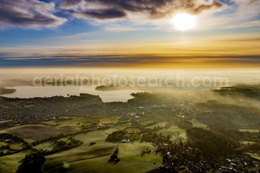 Malente from the bird's eye view: Weather related fog banks and cloud layer in Sonnenaufgang in Malente in the Holsteinische Schweiz in the state Schleswig-Holstein, Germany