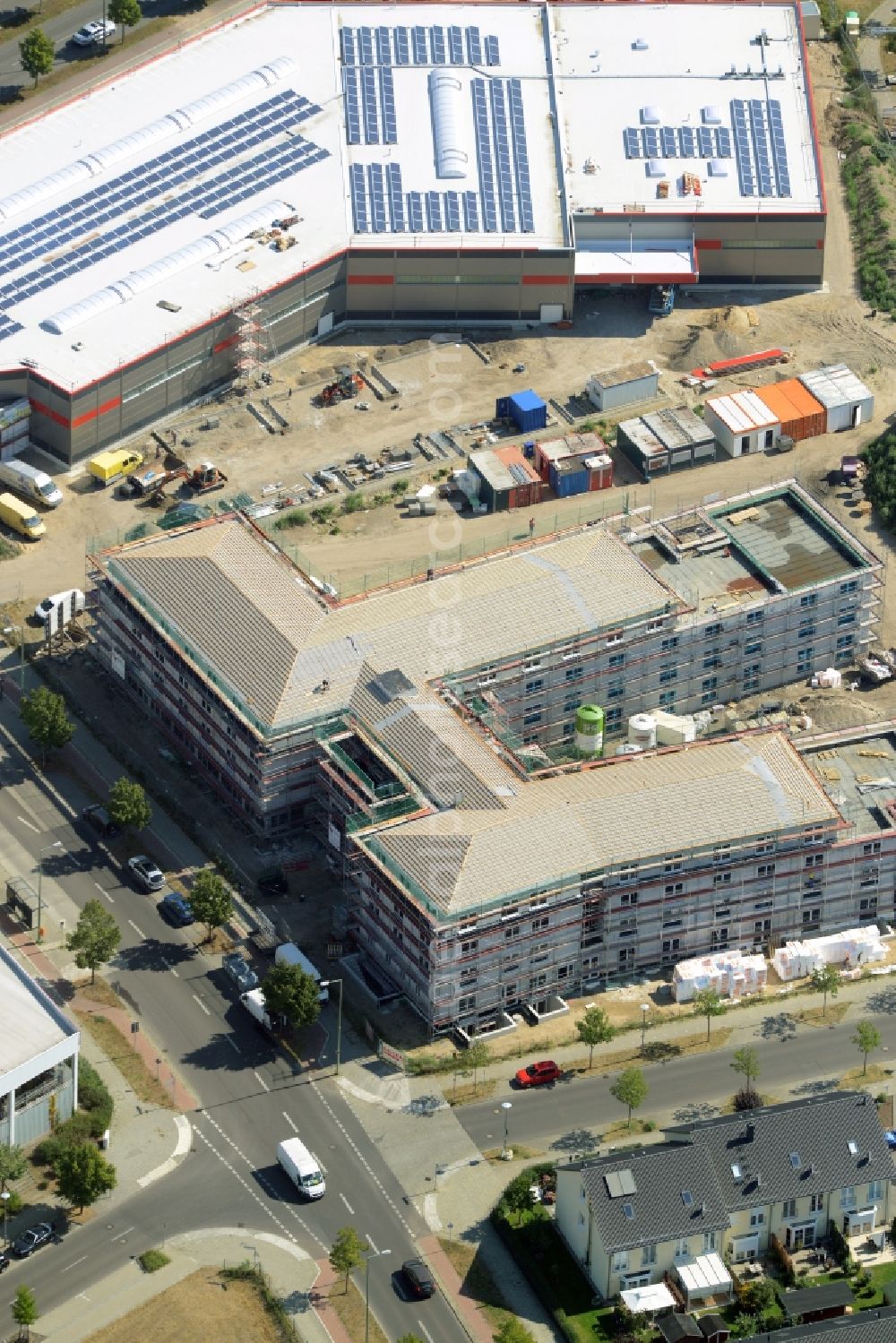 Aerial image Berlin - Building the retirement home on Apollofalteralle in the Biesdorf park of the district of Marzahn-Hellersdorf in Berlin in Germany. The construction site is located in the development area of Biesdorf-Sued. The project is run by Deisen Bau and was designed by Milkoweit Architekten Cohrs Plaasch GbR. The building is being constructed next to a new store on B1/B5 road