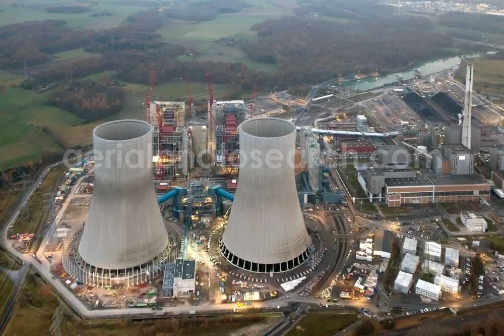 Hamm from the bird's eye view: Construction site of the Westfalen power plant at dusk. The coal-fired power plant of RWE in the Siegenbeckstrasse in Schmehausen district in Hamm in North Rhine-Westphalia is extended by the coal blocks D and E with two cooling towers