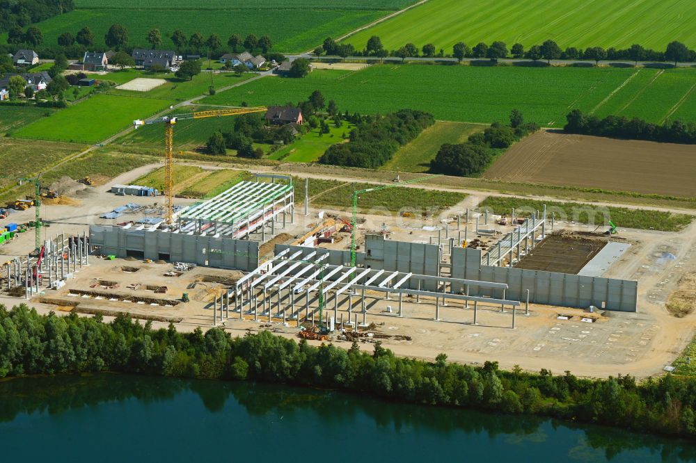 Weeze from the bird's eye view: New construction site for the construction of buildings and production halls on the factory premises for the production of heavy corrugated cardboard on the street Am Sandthof in the district of Goch in Weeze in the federal state of North Rhine-Westphalia, Germany